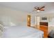 Spacious bedroom with hardwood floors, a ceiling fan, closet space and adjoining bathroom at 256 Marilyn Cir, Cary, NC 27513