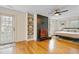 Bedroom featuring hardwood floors, a striking fireplace and hearth, built-in shelving and outside access at 256 Marilyn Cir, Cary, NC 27513