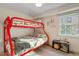 bedroom features a red bunk bed, side table, and a window with natural light at 256 Marilyn Cir, Cary, NC 27513