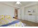 Bedroom features floral bedding, ceiling fan and built-in dresser drawers at 256 Marilyn Cir, Cary, NC 27513