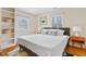 Well-lit bedroom featuring hardwood floors, multiple windows, and ample closet space for storage at 256 Marilyn Cir, Cary, NC 27513