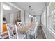 Bright dining room with a large table and plenty of natural light from surrounding windows at 256 Marilyn Cir, Cary, NC 27513
