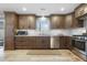 Updated kitchen with dark wood cabinetry, stainless steel appliances, and tile flooring at 256 Marilyn Cir, Cary, NC 27513