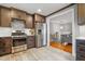 Well-appointed kitchen featuring stainless steel appliances, dark cabinetry, and tile floors at 256 Marilyn Cir, Cary, NC 27513
