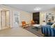 Bright living room with view to backyard; features fireplace, shelving and comfortable seating at 256 Marilyn Cir, Cary, NC 27513