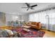 Bright living room with a large window, staircase, hardwood floors, and a decorative rug at 256 Marilyn Cir, Cary, NC 27513