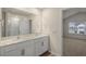 Bathroom with double sinks, a large mirror, and access to the bedroom at 261 Canopy Dr, Graham, NC 27253
