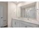 Bathroom vanity with double sinks, white cabinets, and a large mirror at 261 Canopy Dr, Graham, NC 27253
