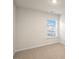Bright bedroom featuring a large window offering natural light and neutral carpeting at 261 Canopy Dr, Graham, NC 27253