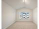Bedroom with a window view of the neighborhood, neutral walls, and carpeting at 261 Canopy Dr, Graham, NC 27253