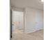 Hallway featuring multiple doors, neutral walls and plush carpeting at 261 Canopy Dr, Graham, NC 27253