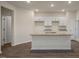 Kitchen featuring white cabinets, granite countertops, and stainless steel sink at 261 Canopy Dr, Graham, NC 27253