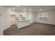 Bright, open-concept kitchen featuring white cabinets and a granite countertop island at 261 Canopy Dr, Graham, NC 27253