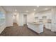 Open-concept kitchen with white cabinets, granite island, stainless sink, and modern design at 261 Canopy Dr, Graham, NC 27253