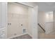Convenient laundry room with washer/dryer hookups and ample shelving for storage solutions at 261 Canopy Dr, Graham, NC 27253