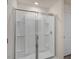 Modern walk-in shower with glass doors and built-in shelving at 261 Canopy Dr, Graham, NC 27253