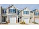 Charming townhome featuring a one car garage, neutral siding, brick accents, and a well manicured front yard at 267 Canopy Dr, Graham, NC 27253