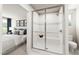 Modern bathroom featuring glass shower with built-in seat and neutral tile design, plus a glimpse of the bedroom at 27 Artesa Ct, Fuquay Varina, NC 27526