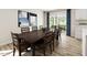 Dining room with a wooden table seating eight and sliding glass doors leading to the backyard at 27 Artesa Ct, Fuquay Varina, NC 27526