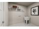 Functional laundry room with a utility sink, wire shelving, decor and ample space at 27 Artesa Ct, Fuquay Varina, NC 27526