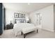 Bright bedroom with a large bed, stylish decor, and a glimpse into the modern bathroom at 27 Artesa Ct, Fuquay Varina, NC 27526