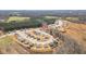 Expansive aerial shot of a new construction community, surrounded by lush wooded areas at 31 Harrow Ter, Roxboro, NC 27574