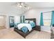 Bright bedroom with a wooden bed, blue pattern bedding, and window with curtain at 31 Harrow Ter, Roxboro, NC 27574