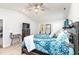 Spacious bedroom with a wooden bed, blue bedding, and two windows with curtains at 31 Harrow Ter, Roxboro, NC 27574