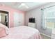 Comfortable bedroom with a pink accent wall, closet, and window at 31 Harrow Ter, Roxboro, NC 27574