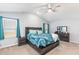 Bright bedroom with a wooden bed, blue pattern bedding, and window with curtain at 31 Harrow Ter, Roxboro, NC 27574