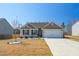 Charming single-story home with a well-maintained lawn, landscaping and a two-car garage at 31 Harrow Ter, Roxboro, NC 27574