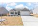 Charming single-story home with neutral siding, manicured landscaping, and attached two-car garage, showcasing curb appeal at 31 Harrow Ter, Roxboro, NC 27574