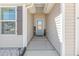 A covered entryway features a blue door and beige siding at 31 Harrow Ter, Roxboro, NC 27574