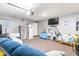 Well-organized garage featuring a refrigerator, storage shelves, and a television for entertainment at 31 Harrow Ter, Roxboro, NC 27574
