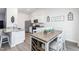 Well-lit kitchen with white cabinets, granite countertops, stainless steel appliances, and a cozy dining area at 31 Harrow Ter, Roxboro, NC 27574
