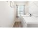 Bright laundry room featuring new washer and dryer with open shelving at 31 Harrow Ter, Roxboro, NC 27574