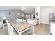 Open-concept kitchen and dining area with luxury vinyl plank flooring, stainless appliances, and comfortable seating for entertaining at 31 Harrow Ter, Roxboro, NC 27574