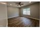 A bedroom with wood floors, gray walls, recessed lighting, and a window overlooking a woodsy area at 3273 Argyll Dr, Sanford, NC 27332