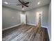 Bedroom featuring gray walls, wood flooring, recessed lighting, a ceiling fan, and access to two rooms at 3273 Argyll Dr, Sanford, NC 27332