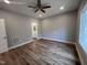 Bedroom featuring gray walls, wood flooring, recessed lighting, a ceiling fan, and an ensuite bath at 3273 Argyll Dr, Sanford, NC 27332