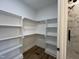 Spacious walk-in closet featuring a custom shelving system, with built-in shelving and wood-look flooring at 3273 Argyll Dr, Sanford, NC 27332