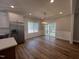Dining area with sliding glass doors to the deck, modern light fixture, and stainless refrigerator at 3273 Argyll Dr, Sanford, NC 27332