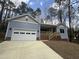 Charming single-story home featuring a garage and covered front porch with wood railing at 3273 Argyll Dr, Sanford, NC 27332