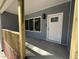 Close-up of covered front porch showing the home's entrance and sidelight window at 3273 Argyll Dr, Sanford, NC 27332
