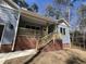 Quaint home featuring a brick foundation, covered porch and light blue vinyl siding at 3273 Argyll Dr, Sanford, NC 27332