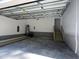 Spacious two-car garage featuring block walls, a concrete floor, ample lighting and an attached stairway at 3273 Argyll Dr, Sanford, NC 27332