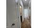 Hallway with hardwood floors, white trim, and doors leading to other rooms in the home at 3273 Argyll Dr, Sanford, NC 27332