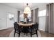 Bright dining room features a stylish light fixture, neutral curtains, and ample natural light, ideal for Gathering meals at 340 Bridle Brook Way, Fuquay Varina, NC 27526