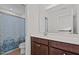Bathroom featuring a blue patterned shower curtain, tile floors, and dark wood vanity with a white countertop sink at 3541 Fairstone Rd, Wake Forest, NC 27587