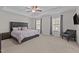Spacious bedroom with a tray ceiling, upholstered headboard, and large windows letting in natural light at 3541 Fairstone Rd, Wake Forest, NC 27587